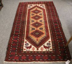 Baluch Rug, the field with a row of diamond medallions enclosed by ivory spandrels and multiple