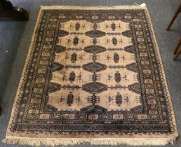 "Bukhara" Rug, the cream field with rows of full and semi güls enclosed by compartmentalised