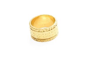 An 18 Carat Gold Band Ring, decorated with cross and scroll motifs, finger size L1/2 The ring is