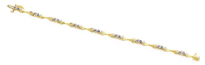 A Tanzanite and Diamond Bracelet, clasp stamped '14K', length 17.3cm Gross weight 9.3 grams.