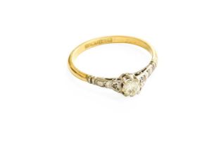 A Diamond Solitaire Ring, the round brilliant cut diamond in a white claw setting, to a yellow