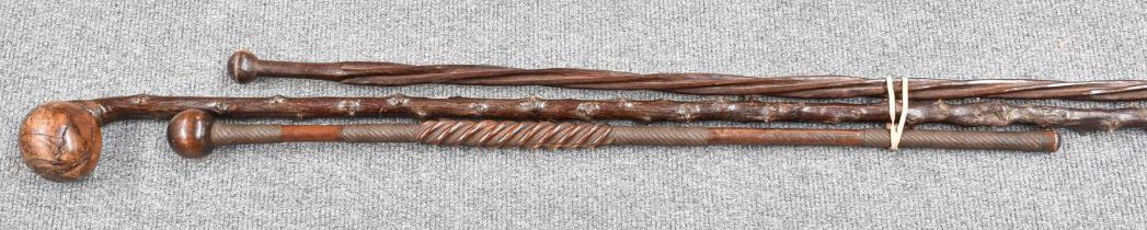 A Zulu Hardwood Knopberrie, the shaft of wrythen form with wirework mounts, with two others (3)