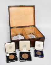 Three Boxed Bronze Award Medals; an Indian princely state silver coin bracelet; a small assortment