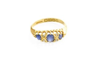 An 18 Carat Gold Sapphire and Diamond Seven Stone Ring, three cushion cut sapphires spaced by