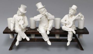 A Set of Three Continental Blanc de Shine Figures of Muscians, with four posy holders on wooden