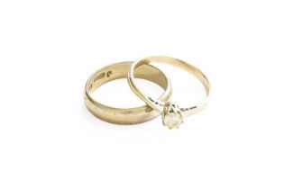 An 18 Carat Gold Textured Band Ring, finger size K1/2; and A Diamond Solitaire Ring, stamped '18CT',