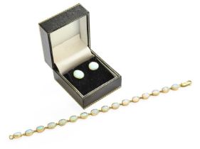 A 9 Carat Gold Opal Bracelet, sixteen chain linked oval cabochon opals in yellow rubbed over