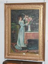 W Mander (Contemporary) A lady arranging flowers in an interior Signed, oil on canvas, 90cm by 60cm