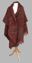 A Late 19th Century Woven Red Paisley Shawl in red, blue, brown and green, with colour block fringe,