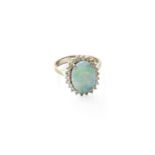 An 14 Carat White Gold Opal and Diamond Cluster Ring, the oval cabochon opal within a border of