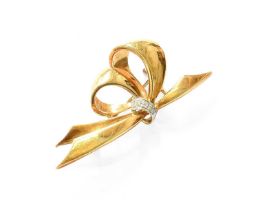 A Diamond Bow Brooch, the yellow plain polished bow motif gathered centrally with round brilliant