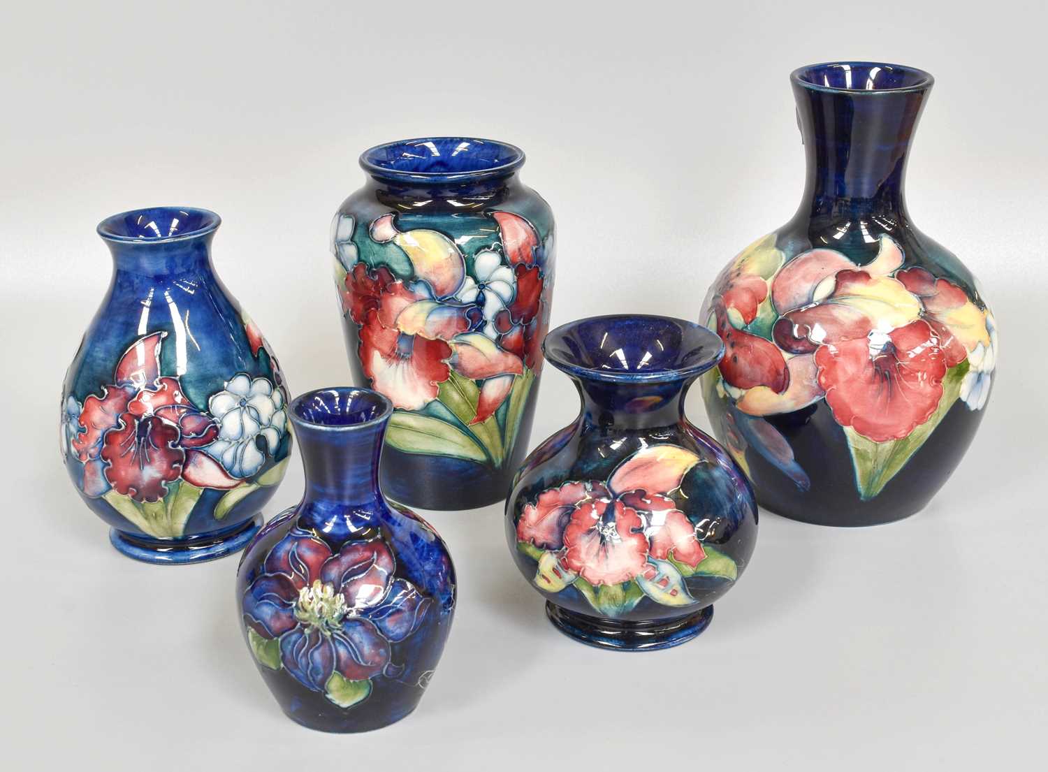 A Walter Moorcroft "Orchids and Spring Flowers" Pattern Bottle Vase, impressed mark and signed, 15cm