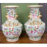 A Pair of 19th Century Canton Famille Rose Vases, of baluster form, everted rims, twin gilt mythical