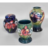 A Walter Moorcroft "Orchids and Spring Flowers" Pattern Vase, of baluster form and green ground,