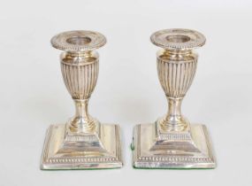 A Pair of Victorian Silver Candlesticks, by Charles Boyton, London, 1893, each on square base with
