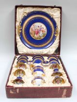 A Vienna Style Porcelain Coffee Set, in fitted case, ground in blue, gilded and printed with