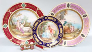 A Pair of Vienna Style Porcelain Chargers, with coloured panelled grounds framing central painted