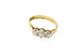 An 18 Carat Gold Diamond Three Stone Ring, the graduated round brilliant cut diamonds in white