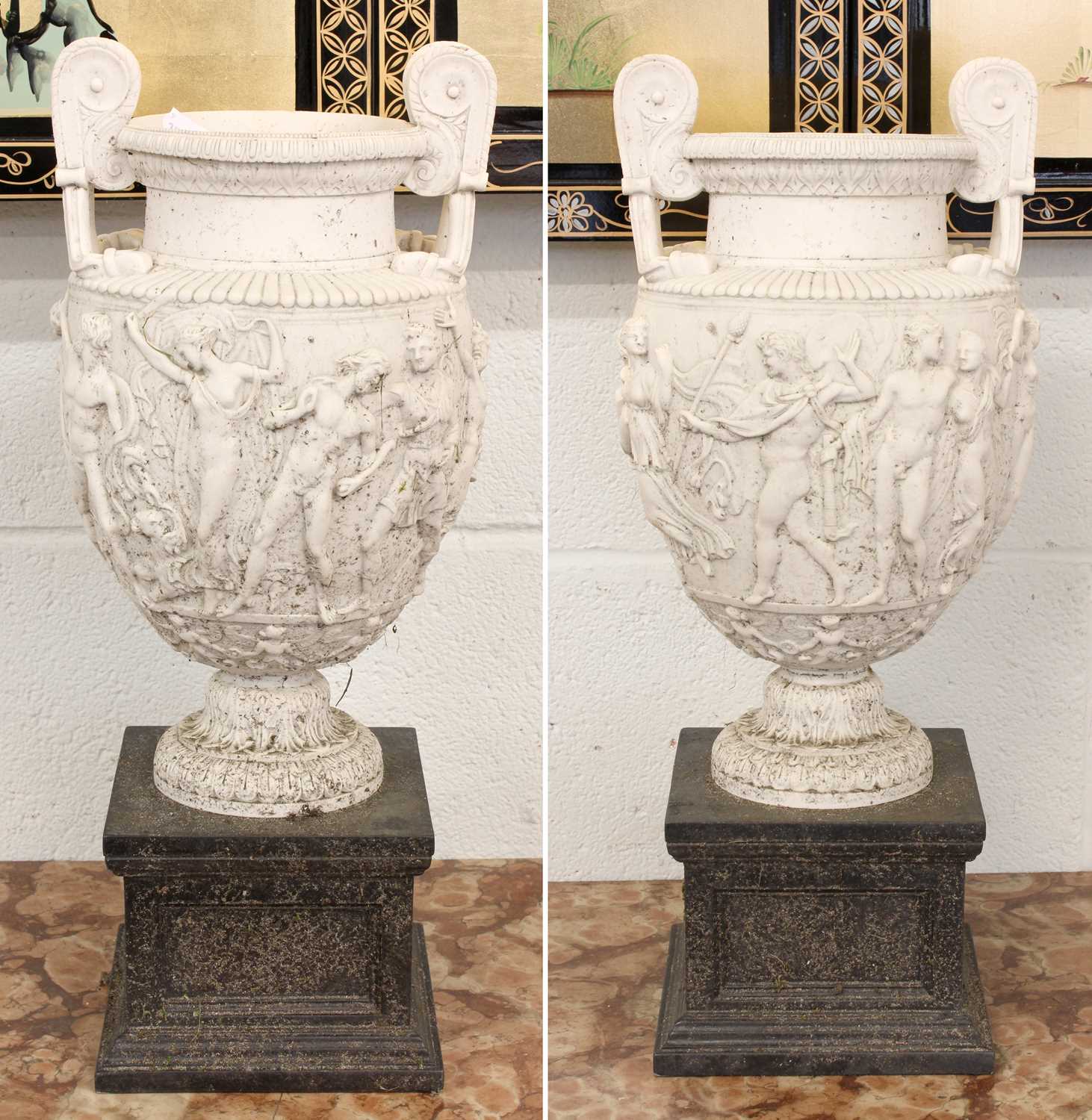 After the Antique a Pair of Composite Urns, modelled after the Townley Vase, raised on square