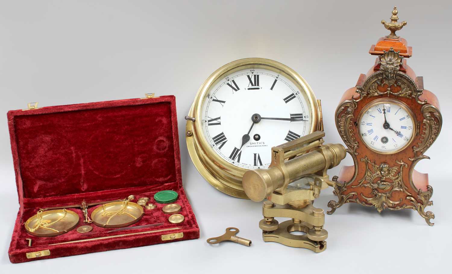 A French Mantel Timepiece, together with a ship's-type Smith's bulkhead wall timepiece, a theodolite