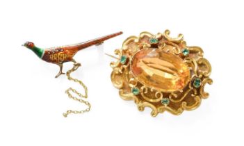 A Citrine and Emerald Brooch, the oval cut citrine in a yellow claw setting, to a scroll frame