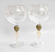 A Near Pair of Murano Glass Wine Goblets, the bowls etched with Bacchanalian scenes over readed