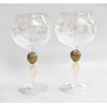 A Near Pair of Murano Glass Wine Goblets, the bowls etched with Bacchanalian scenes over readed