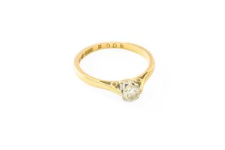 A Diamond Solitaire Ring, the round brilliant cut diamond in a white claw setting, to a yellow