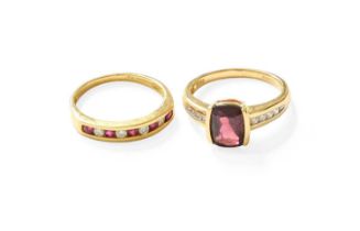 An 18 Carat Gold Garnet and Diamond Ring, the cushion cut garnet in a yellow elongated claw setting,