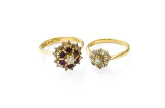 An 18 Carat Gold Diamond Cluster Ring, the central raised round brilliant cut diamond within a