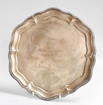 A George V Silver Salver, by Walker and Hall, Sheffield, 1927, shaped circular and on three ball and