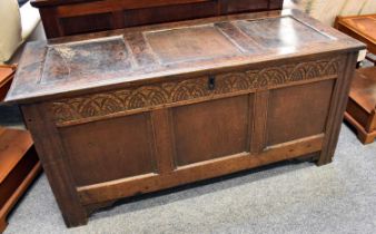A Late 17th/Early 18th Century Oak Panelled Coffer, hinged lid, carved lunette frieze on stile ends,