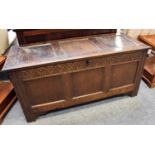 A Late 17th/Early 18th Century Oak Panelled Coffer, hinged lid, carved lunette frieze on stile ends,