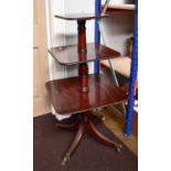 An Early 19th century Mahogany Three Tier Dumb Waiter, rasied on ring turned column supports to four
