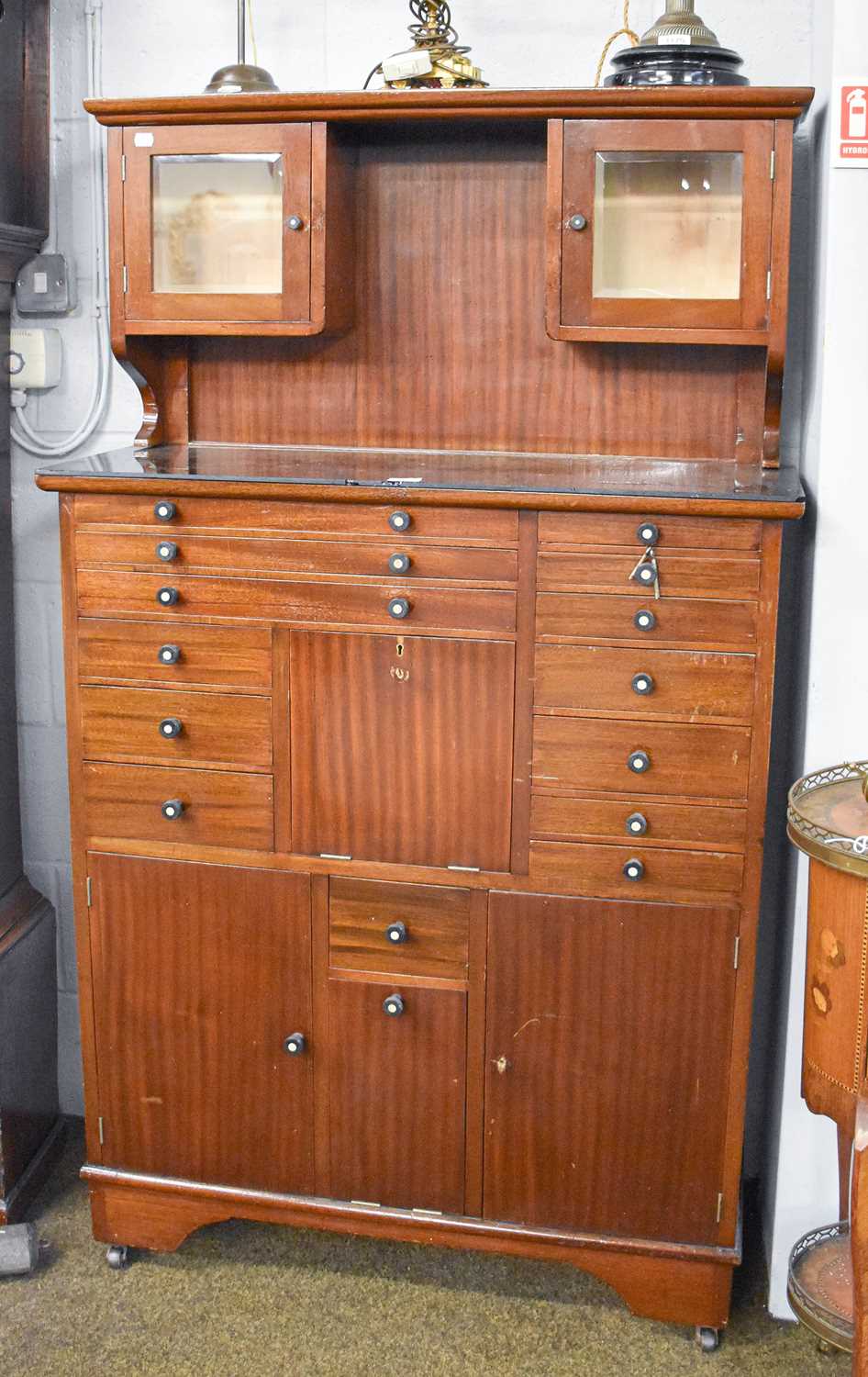 An Early 20th Century Mahogany Dentistry Cabinet, the upper section with two small glazed cupboards,