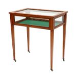 A Victorian Satinwood and Ebony-Strung Bijouterie Table, circa 1900, the glazed hinged lid enclosing