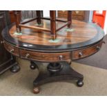 A Regency Rosewood and Oak Crossbanded Drum Table, with four drawers and four dummy drawers,
