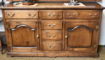 An 18th century Style Oak Dresser Base, with arrangment of six drawers and two cupboards, 90cm by