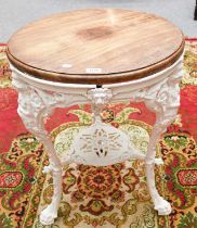 A 19th century White Painted Cast Iron Garden Table, circular wooden top, raised on three figural