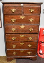 A 19th Century Oak Six Height Chest of Drawers, shaped brass handles and escutcheons, bracket