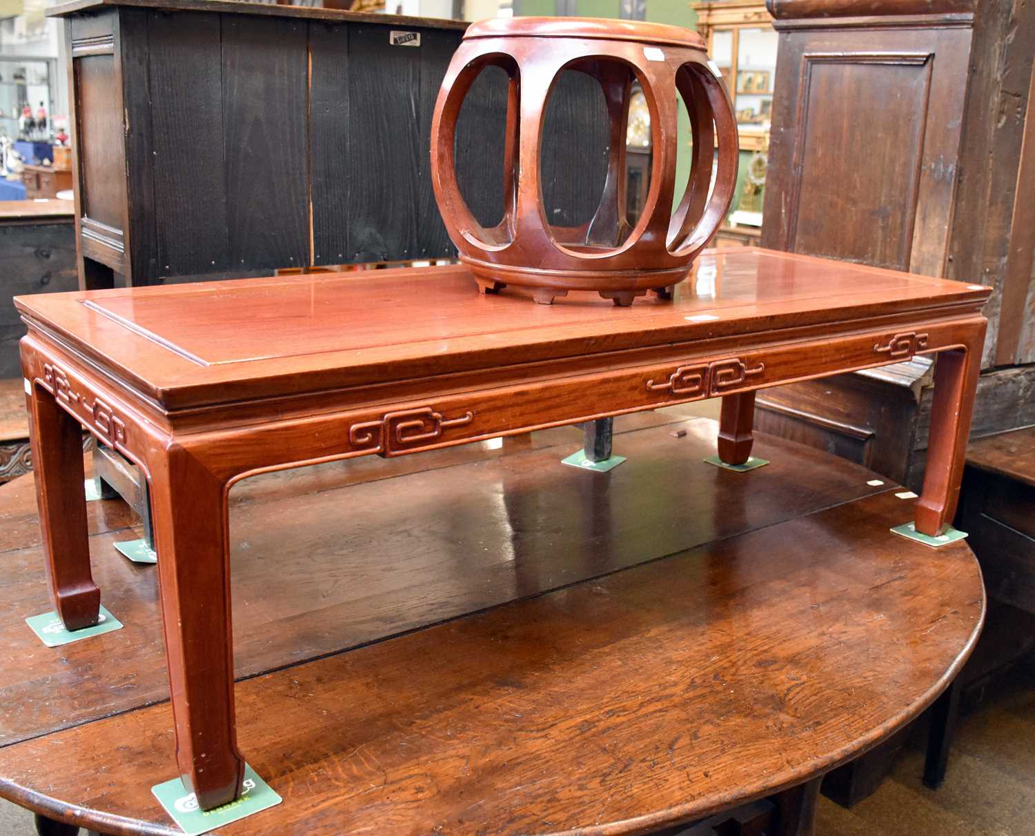 A Chinese Hardwood Rectangular Coffee Table, stylised carvings, square legs, 41cm by 127cm by