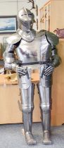 A Modern Reproduction Polished Steel Complete Suit of Armour, on wooden stand 173cm high on its