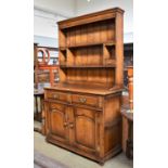 A Titchmarsh & Goodwin Oak Country Dresser with Plate Rack, the base with two drawers above twin