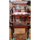 A 19th century Child's Mahogany High Chair, with scroll arms, drop in seat, raised on plinth base,