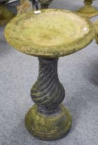 A Stone Bird Bath, circular dished top on wrythen baluster column to plinth base, with maker's mark,