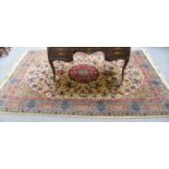 A Machine Made Carpet of Classical Oriental Design, the ivory field with central medallion