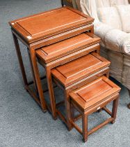 A Chinese Hardwood Nest of Quartetto Tables, the largest 66cm by 51cm by 36cm