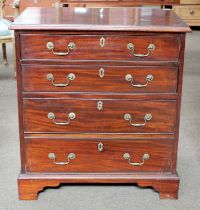 An Early 19th century Mahogany Chest of Four Long Drawers, brass swan neck handles, bracket