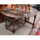 An Early 18th century Oak Gateleg Table, twin drop flaps, raised on turned legs with rectangular