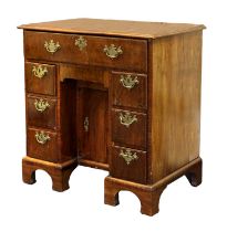 A George II Walnut and Featherbanded Bureau-Table, circa 1740, the crossbanded moulded top above a
